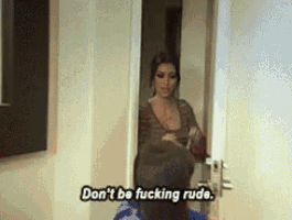 a woman is standing in a doorway and saying " don 't be fucking rude " .