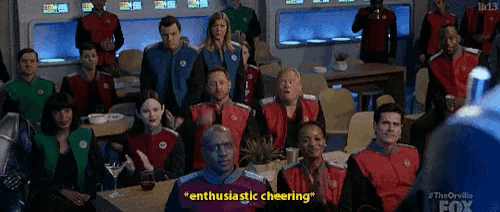 a group of people are sitting in a room with the words " enthusiastic cheering " written on the bottom