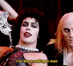 a man and a woman are sitting next to each other and the woman says i 've been making a man .