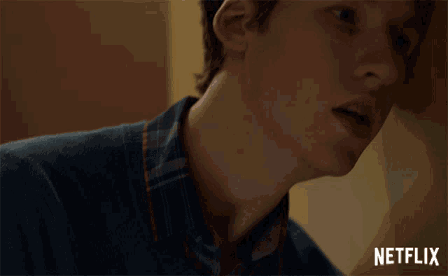 a close up of a person 's face with a netflix logo in the corner