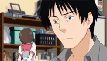 a man is holding a doll in front of a shelf