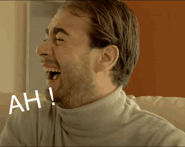 a man with a turtleneck is laughing with ah written on the bottom of his face