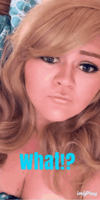 a close up of a woman 's face with the words what in blue letters