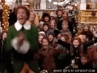 a man in a green suit is standing in front of a crowd of people and says make gifs at gifsoup.com