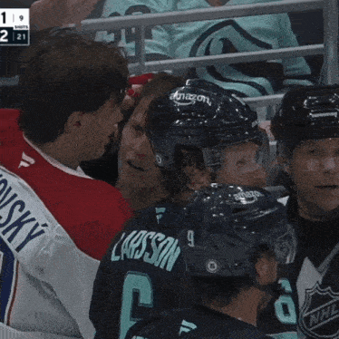 a hockey player with the number 20 on his jersey talks to another player