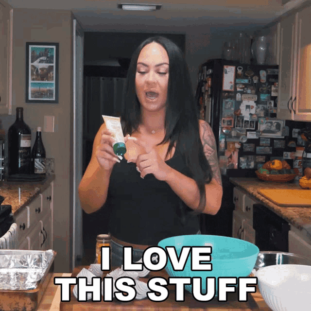 a woman in a kitchen with the words " i love this stuff " below her