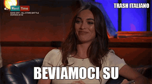 a woman sitting on a couch with the words beviamici su written on the screen