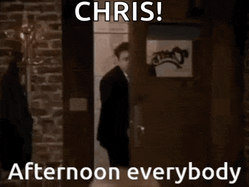 a man in a suit and tie is standing in a doorway with the words chris afternoon everybody below him