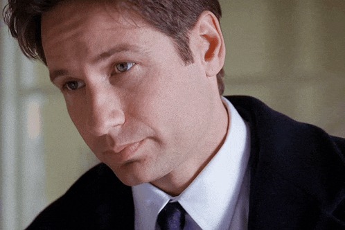 a close up of a man 's face with his eyes closed