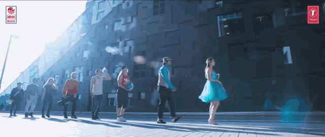 a group of people walking in front of a building with the number 1
