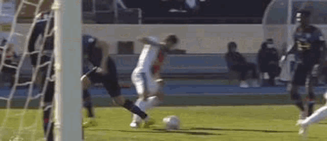 a man is kicking a soccer ball on a field .