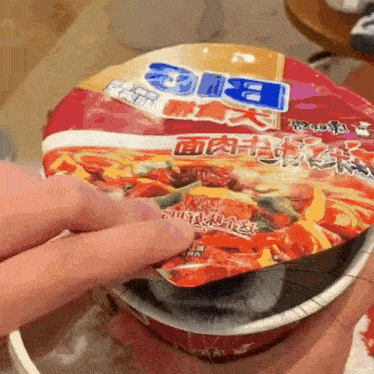 a person is holding a bowl of big noodles