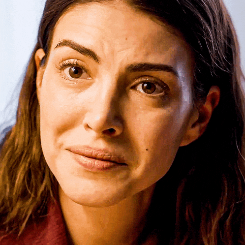 a close up of a woman 's face with a serious expression