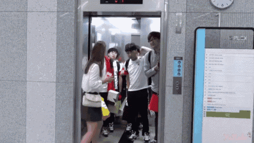 a group of people are standing in an elevator with a sign that says ' splex ' on it