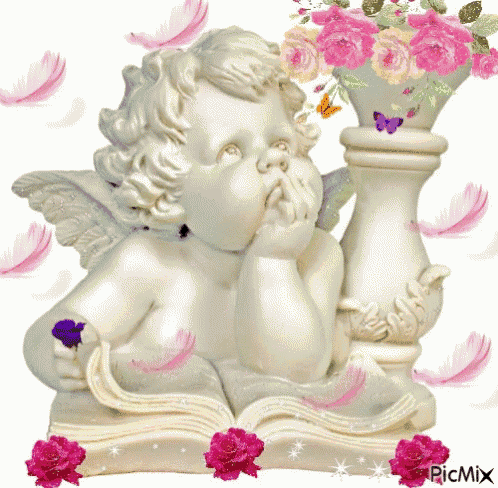 a statue of an angel sitting on an open book with pink roses around it