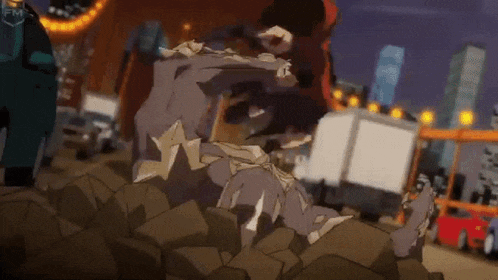a person is laying on top of a pile of rocks in a city .