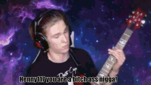 a man playing a guitar with the words henny17 you are a bitch ass nigga on the bottom