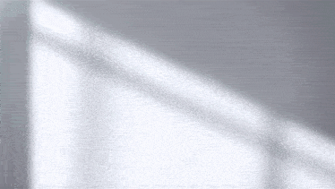 a shadow of a window on a white wall