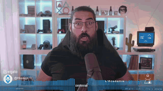 a man with a beard and glasses is talking into a microphone with a watermark that says ' audio ' on it