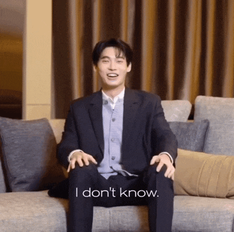 a man in a suit is sitting on a couch and says i don t know