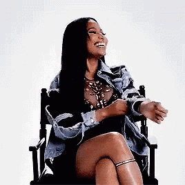 a woman is sitting in a chair with her legs crossed .
