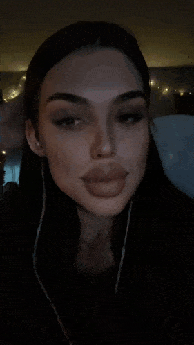 a close up of a woman 's face with dark hair