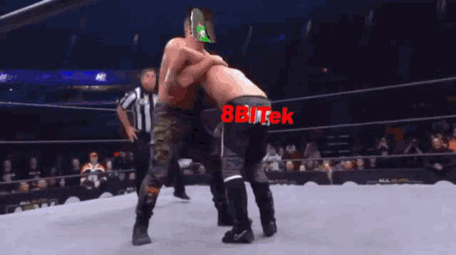 two wrestlers in a ring with 8bitek in red