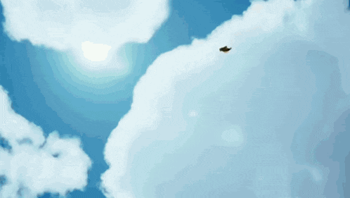 a person is flying through a blue sky with a cloud in the foreground