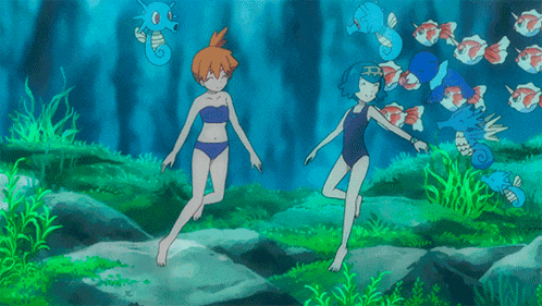 a couple of girls in bikinis are standing in the water