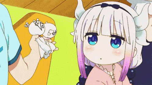 a girl with horns is sitting next to a man holding a tissue .