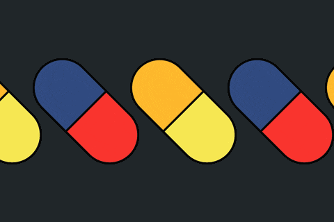 a row of pink yellow and purple pills on a dark background