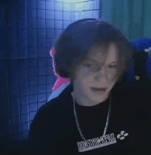 a person wearing headphones and a black shirt that says do it will