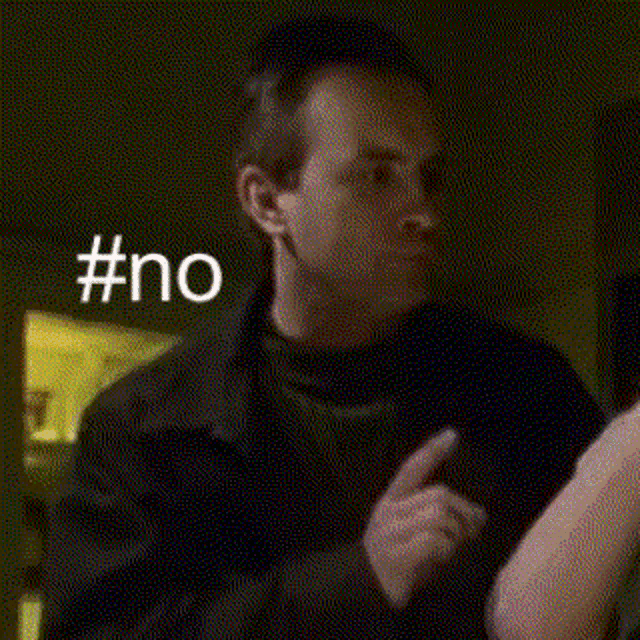a man is holding a woman 's arm in a dark room while a woman looks on .