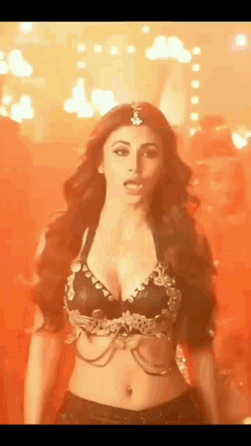 a woman in a very revealing top is dancing in a room .