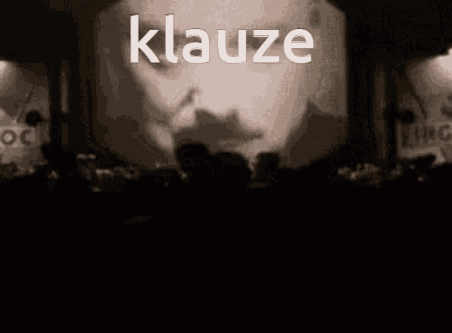a black and white photo of a man with the word klauze written above him