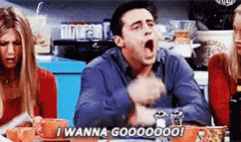 a man is sitting at a table with his mouth open and says i wanna goooooo !