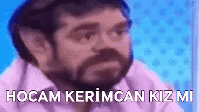 a man with a beard is making a funny face while talking to someone .