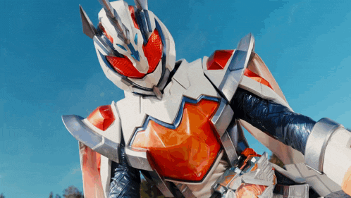 a close up of a superhero with a blue sky behind him