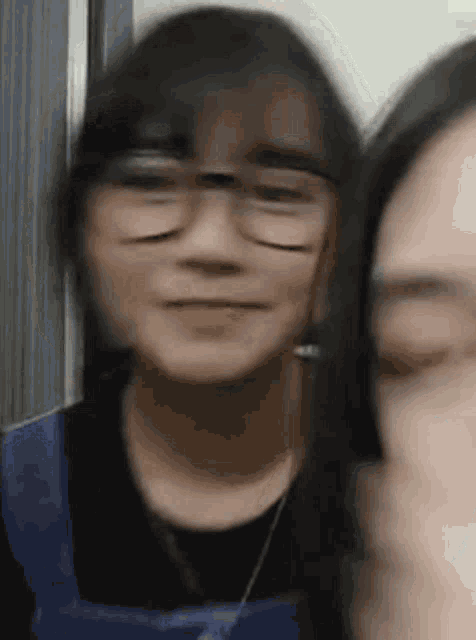 a close up of a woman wearing glasses making a funny face