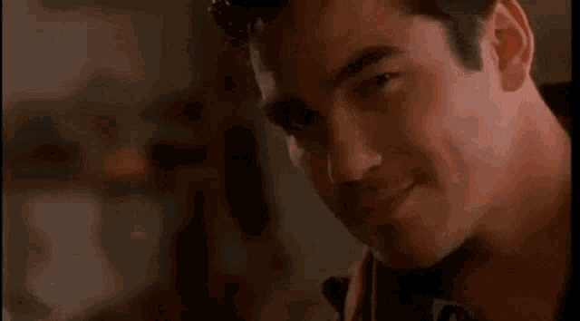 a close up of a man 's face with a serious look on his face .