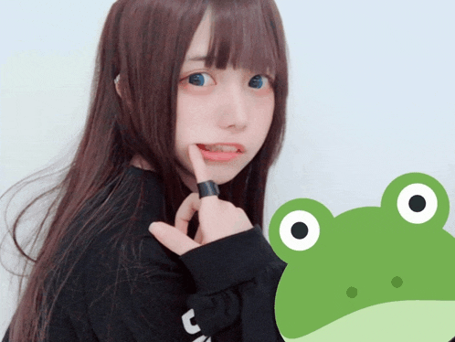 a girl with long brown hair is holding her finger to her mouth next to a green frog with big eyes