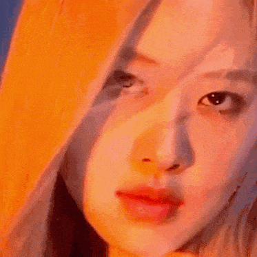 a close up of a woman 's face with a hoodie on .