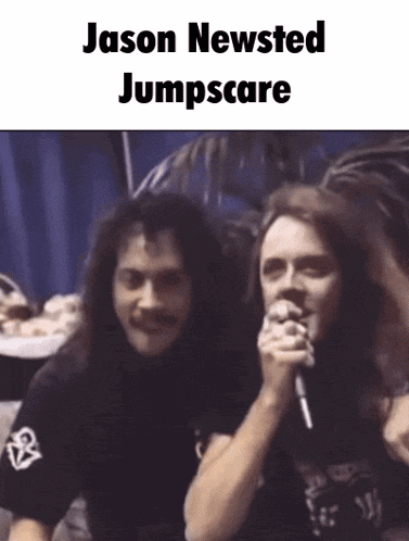 two men are standing next to each other and one is holding a microphone with the words jason newsted jumpscare on it