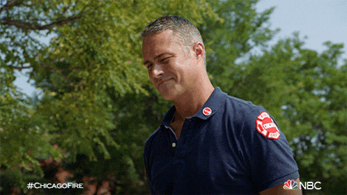 a man in a blue shirt with a patch that says chicago fire on it