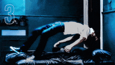 a person is laying on a bed with the number 3 behind them