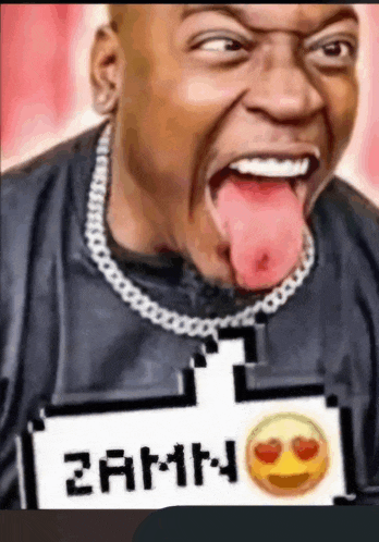 a man with his tongue hanging out is wearing a shirt that says zamn