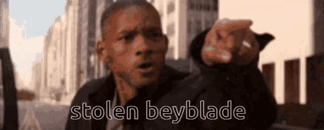 a man is pointing at the camera with the words stolen beyblade behind him