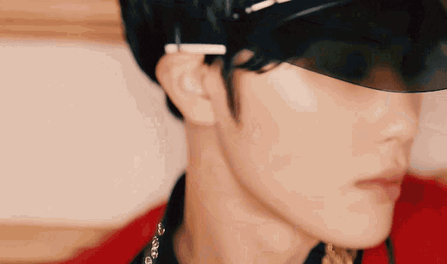 a close up of a person 's face wearing a hat