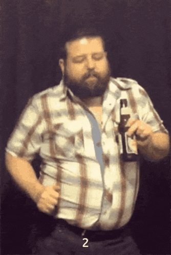 a man in a plaid shirt is holding a bottle of beer and the number 2 is above him