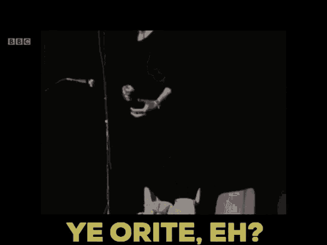 a woman singing into a microphone with the words ye orite eh behind her